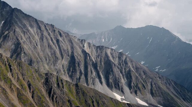 Winter mountains in clouds and bursts of steam from fumaroles