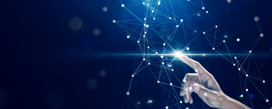 A human hand interacts with a glowing digital network, symbolizing technology, innovation, and data connectivity.