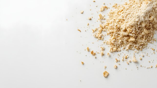 Crushed graham cracker crumbs spilled across a white surface