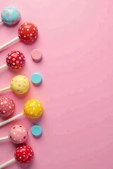 Colorful selection of sweet lollipops and candies on pastel pink background, sugary, assortment, confectionery
