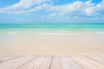 Fototapeta premium Empty wood table mockup with beautiful tropical beach background and copy space for text, Mock up for your product display and montage in summer season. vacation and wallpaper travel concepts