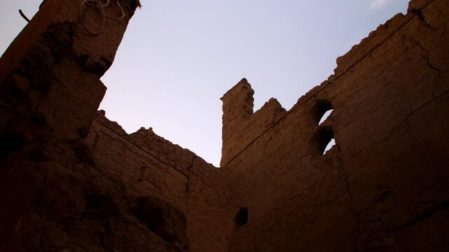 low angle view of old ruins in the rich cultural heritage of Oman at Bait Al Safah, a living museum in Al Hamra showcasing traditional Omani life