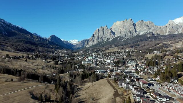 aerial drone fly above scenic italian alps landscape in Cortina d&rsquo;Ampezzo village town famous for olympic game