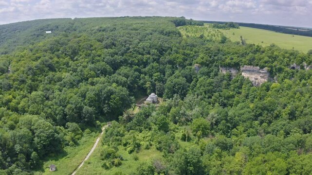 Approachig orbit drone shot of Demir Baba Teke, a religious historical site in Razgrad province in Bulgaria.