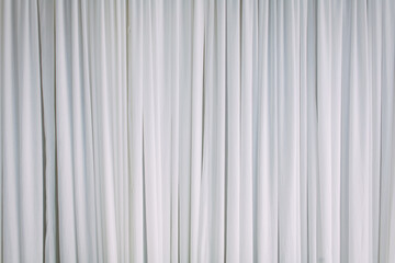 Obraz premium The white wavy curtains are perfect for a background.