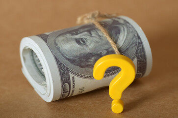 Financial Uncertainty: Rolled US Dollar Bills with Question Mark