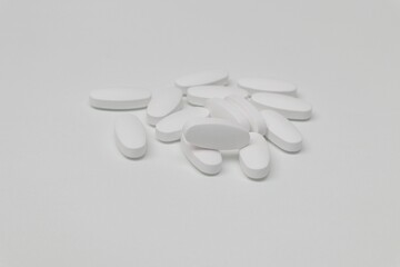 Pile of medicine pills on white background