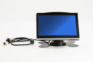 Dashboard monitor with stand and cable setup for enhanced visual display in vehicle