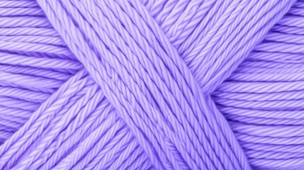 Fototapeta premium A close-up view of a soft, lavender yarn, showcasing its twisting strands and texture, ideal for knitting and crafting projects, macramé texture