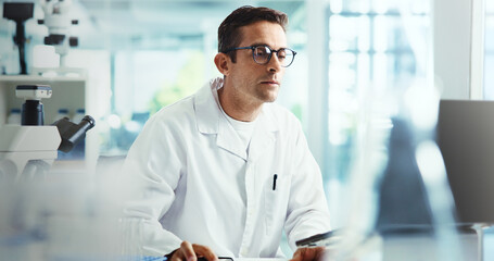 Fototapeta premium Biology, man or scientist on laptop in laboratory for chemical experiment, research with medical technology. Study, reading or medicinal chemist with pharmaceutical project or healthcare innovation