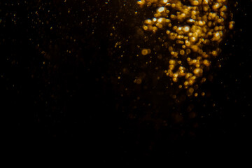 Blurred photo with golden dots visible glittering, shining brightly look and feel luxurious Suitable for use as a wallpaper