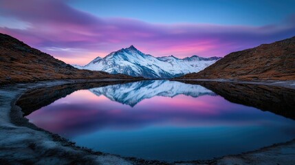 Obraz premium Mountain range landscapes concept. Breathtaking mountain reflection in a tranquil lake at sunset, showcasing vibrant colors.