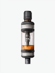 Naklejka premium Close-up of a vape tank with glass and metal parts, showcasing details of its internal mechanism and a liquid reservoir.