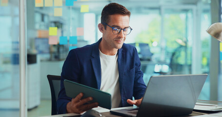 Office, businessman and tablet with laptop for reading, typing article and research for news story....