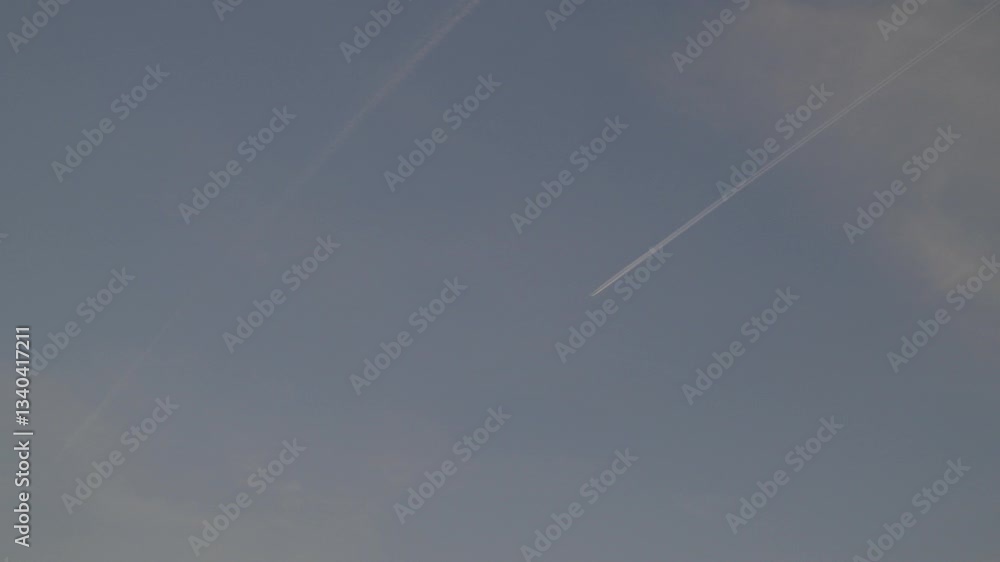 Aufkleber sky with contrails from passing airplanes, clear weather and calm atmosphere