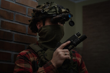 Civilian tactical shooter in tactical gear, helmet with night vision device on his head in the...