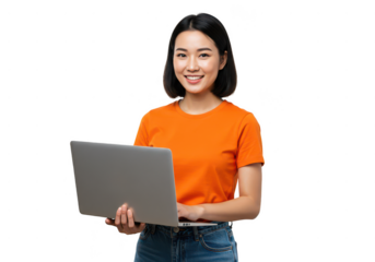 Smiling asian woman in orange shirt holding a laptop against a black background for work or study