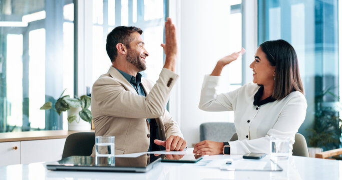 High five, motivation and success with business people in office together for bonus, goals or target. Celebration, milestone or winner with man and woman employee in boardroom for deal or partnership