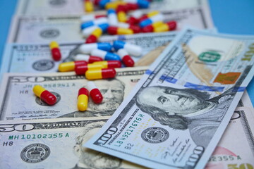 Dollar bills and a scattering of medicines on the table.
