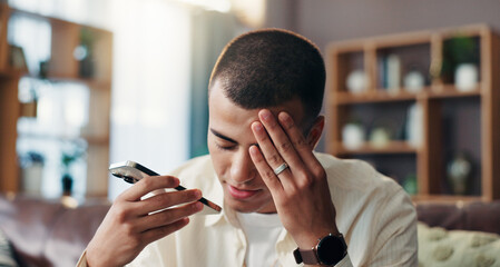 Frustrated man, headache and phone with speaker for audio message, recording or technical issue at home. Male person, mistake or talking with mobile smartphone or migraine for debt review or bad news