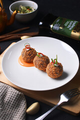 a plate of fried chicken ball with vegetables