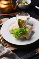 kebab with vegetables filling with mozzarella on a white plate