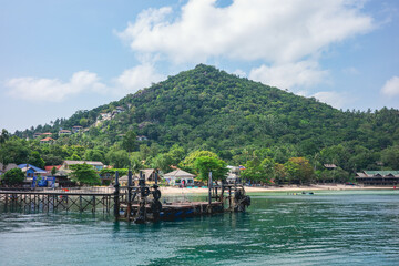 A beautiful landscape of the private boat dock to enter the resort with mountain in the background on Koh Tao, Thailand. A famous summer holiday destination for both locals and foreigners