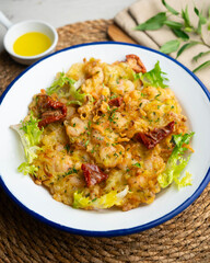 A Spanish tapa of Tortillas de camarones. Small portions of fried fritters with shrimp and vegetables.