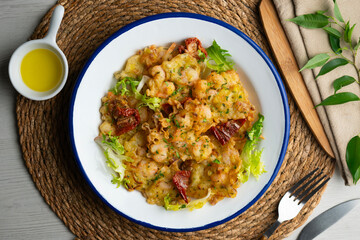 A Spanish tapa of Tortillas de camarones. Small portions of fried fritters with shrimp and vegetables.