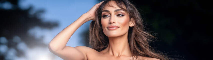Naklejka premium Woman with flowing hair striking a pose outdoors during golden hour light