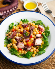 Octopus, chickpea, and vegetable salad. Traditional Spanish octopus salpicon tapa recipe.