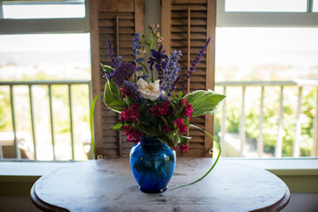 Vibrant Wildflower Bouquet in Blue Glass Vase
