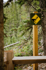 Cliff warning sign on a hiking trail in Canmore, Alberta