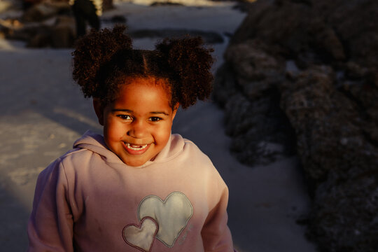 Mixed race ethnicity girl smiling front teeth missing