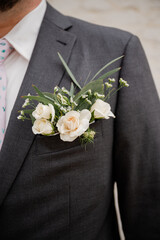 Groom in charcoal gray suit with modern pocket boutonniere