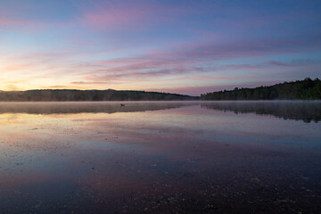 Fototapeta premium Soft Sunrise Over a Tranquil Lake in New Hampshire