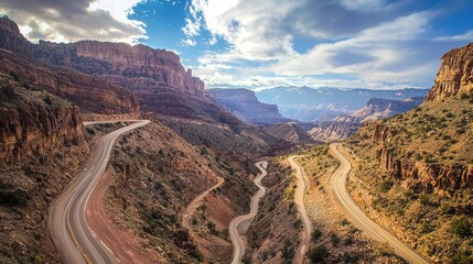 Winding Road in the Canyon: A scenic overlook capturing the grandiosity of a canyon, with a winding road disappearing into the horizon under a cloudy sky, showcasing the raw beauty of nature.