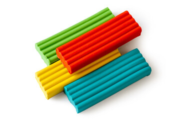 Fototapeta premium Multi-colored plasticine bricks on a white background. Childrens plasticine close-up.