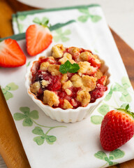Homemade strawberry crumble in an individual mold, baked in the oven.