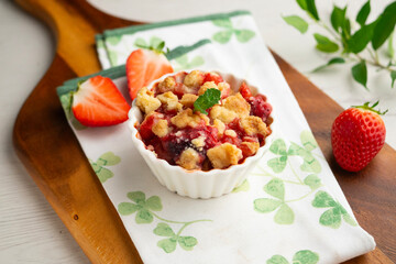 Homemade strawberry crumble in an individual mold, baked in the oven.