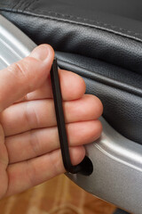 Assembly and repair of a modern leather armchair. A hand with a wrench close-up.