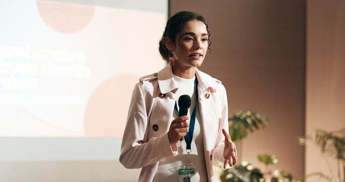 Business woman, conference and presentation for speaker in seminar room for wellness training. Education, forum speech and microphone with corporate coach on stage for public relations or development