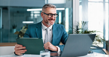 Mature, businessman and tablet with laptop in office, financial report and auditing for corporate...