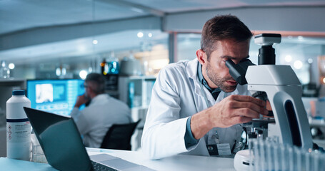 Science, laptop and microscope with man in laboratory for DNA discovery, healthcare or research....