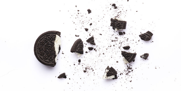 Delicious Oreo biscuits with chocolate and cream on white background	
