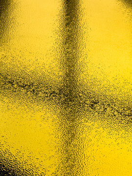 A reflection of a yellow object on a surface