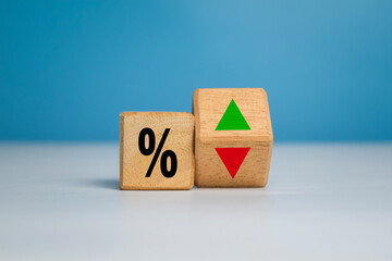 percentage symbol with up and down arrow on wooden isolated on white and blue background. concept of interest rate financial and mortgage rate growth