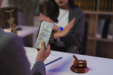 Lawyer refusing a bribe from a client during a meeting in a law office, showcasing unwavering...