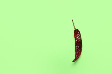 Dry hot chili pepper on pale green background
