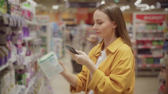 Woman browses gaskets in a store, checking her phone for product details and compatibility. She examines options to ensure the right fit for her needs.